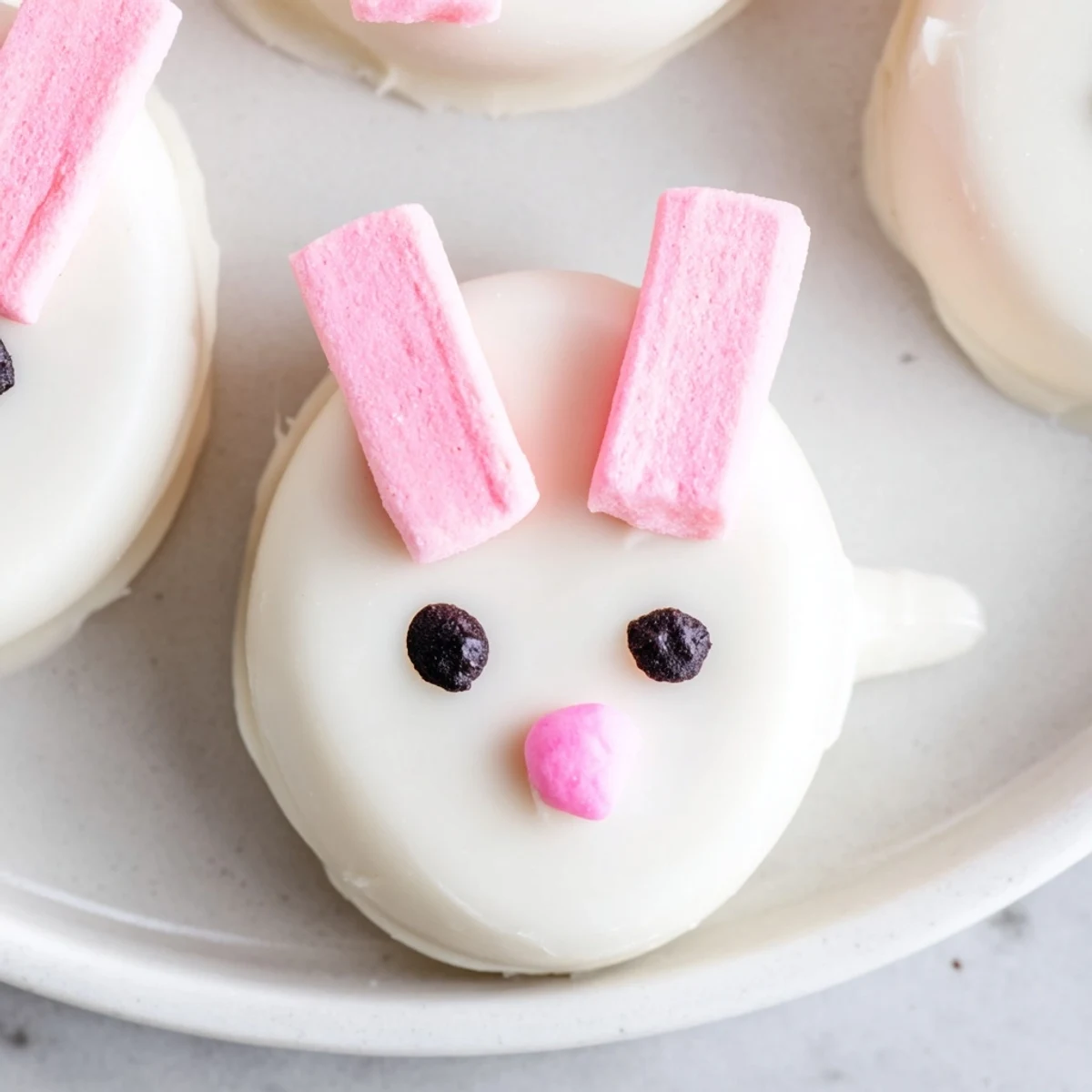 Adorable Oreo truffle bunnies featuring candy-coated ears, cute faces, and fluffy marshmallow tails ready for spring celebrations