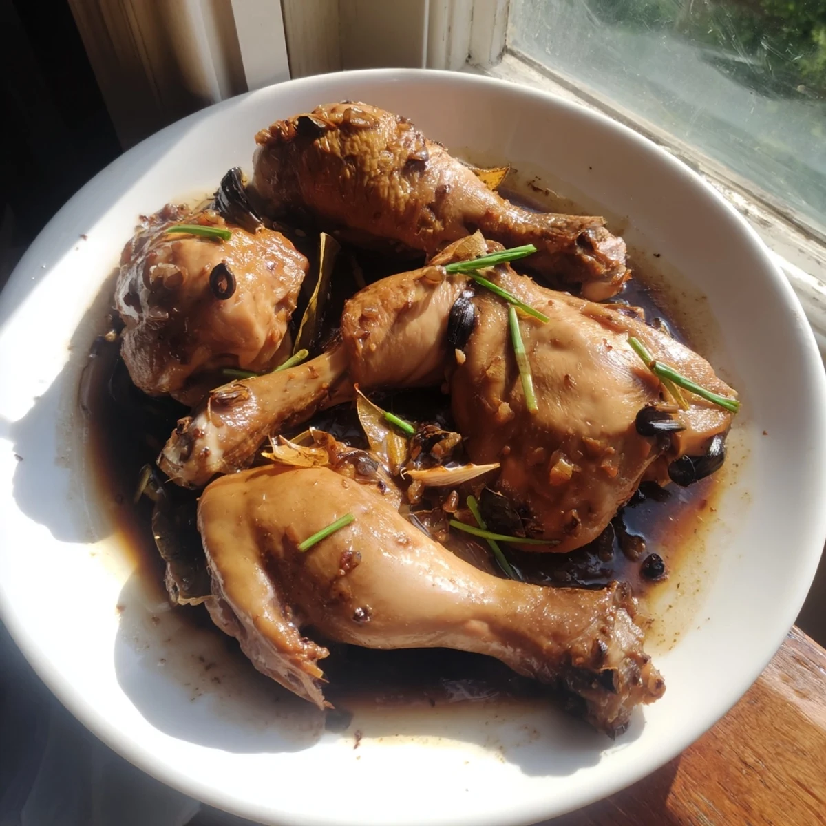 Savory Filipino Chicken Adobo with thickened glaze served over fluffy jasmine rice with scallions