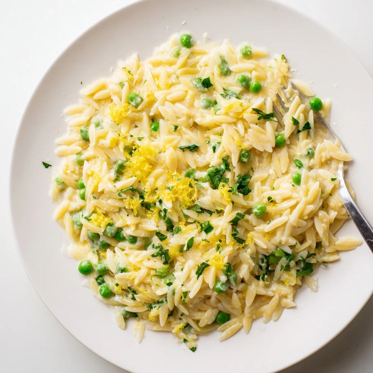 Close-up of tender lemon orzo tossed with butter and parmesan for a Mediterranean side dish