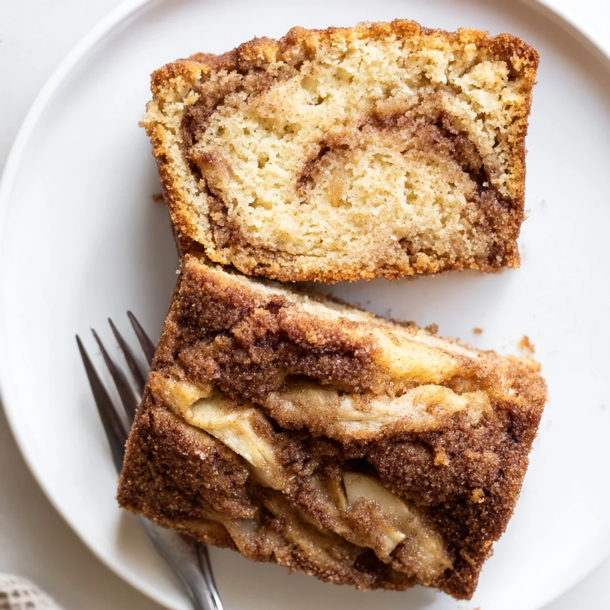 Warm cinnamon apple bread fresh from the oven with sugary cinnamon swirl top