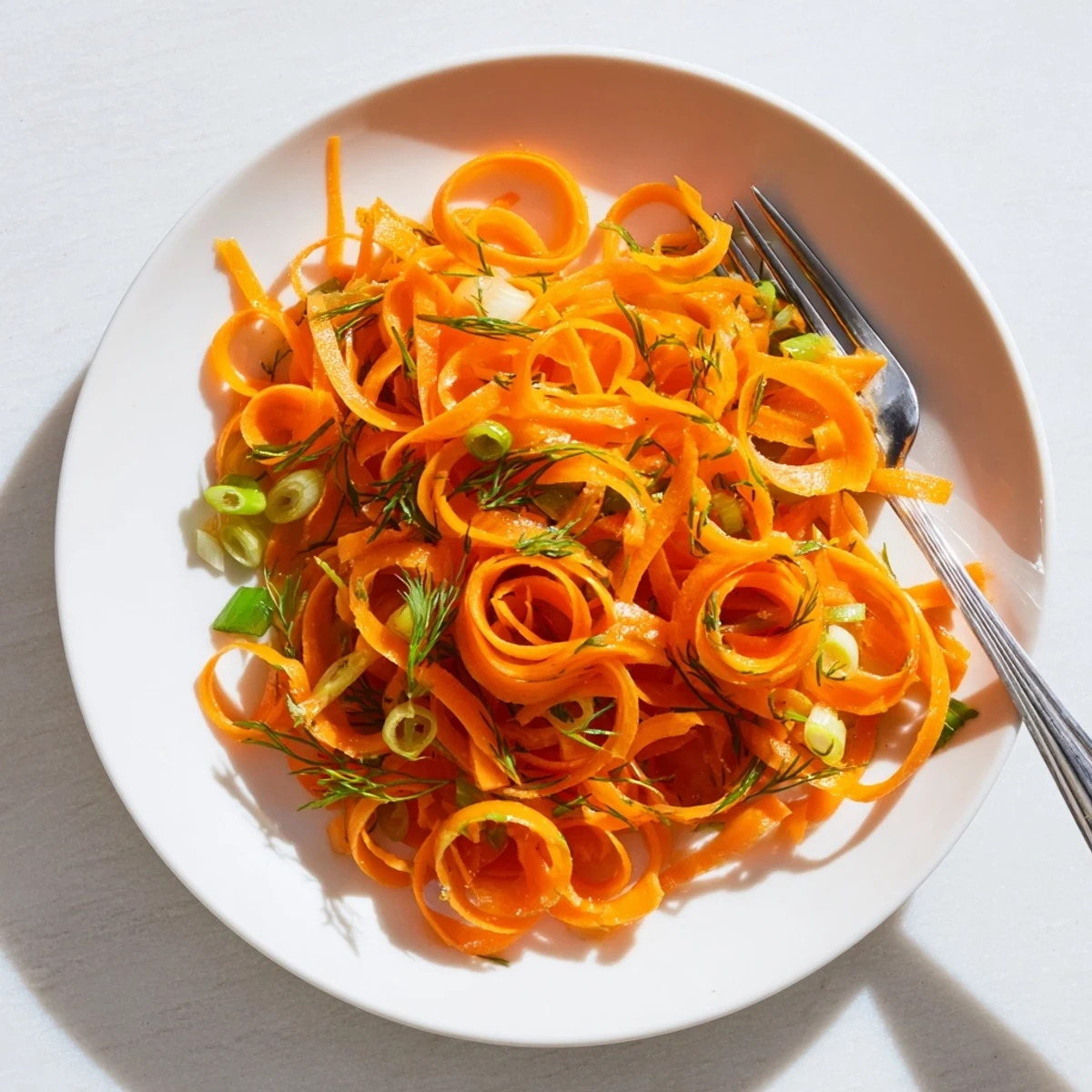 Crisp julienned carrots tossed in zesty marinade for Marinated Lemon Dill Carrot Salad