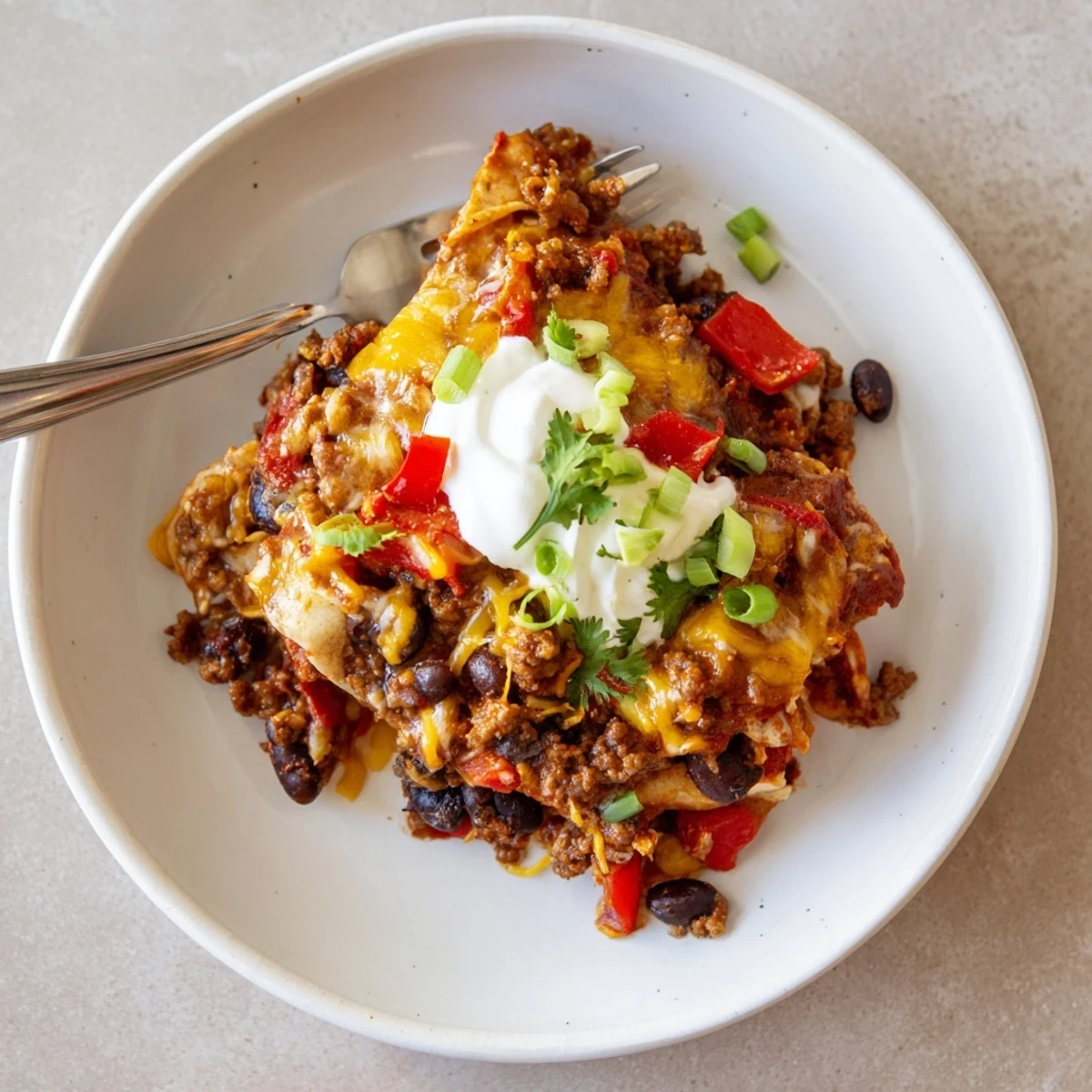 Beef Skillet Enchiladas fragrant with cumin, gooey cheese, and fresh cilantro