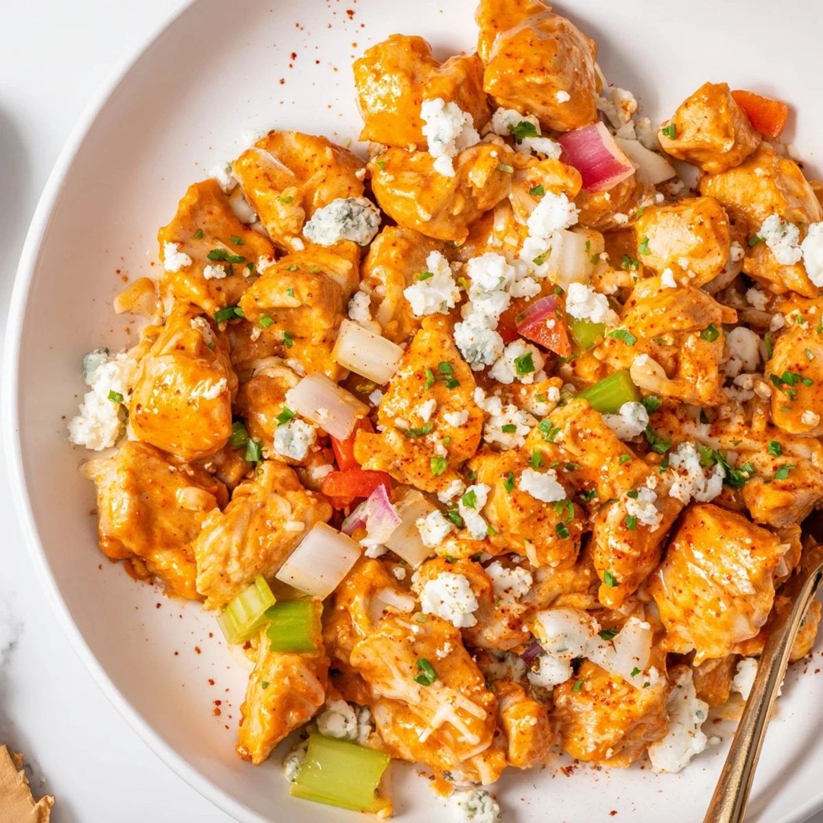 Keto Buffalo Chicken Skillet sizzling in pan with creamy sauce and melted mozzarella  