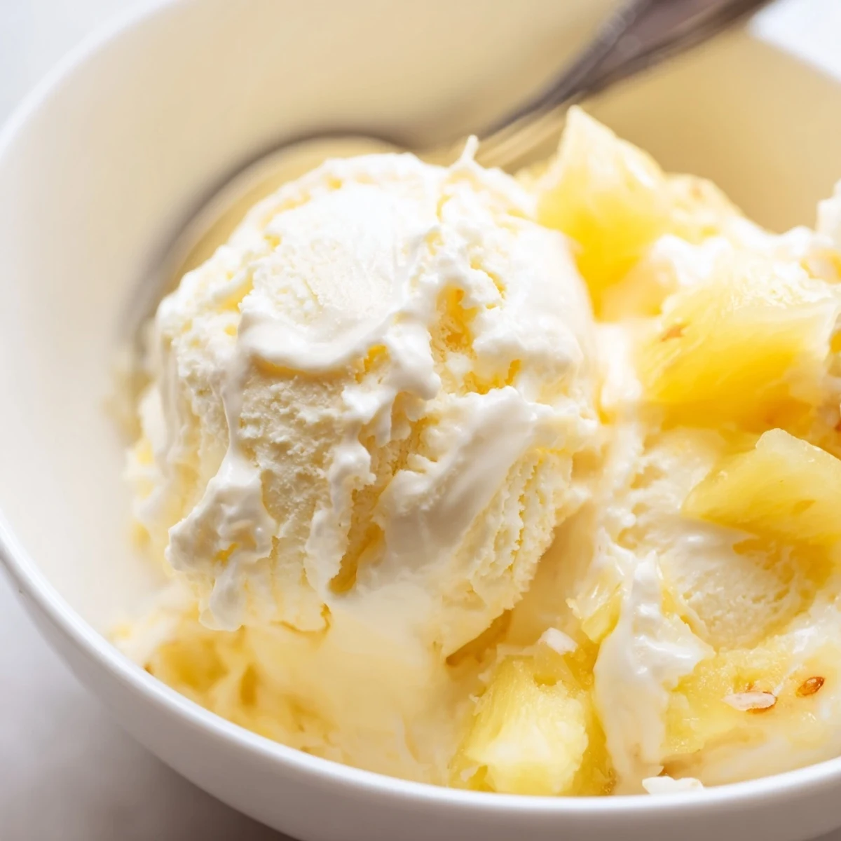 Creamy Pineapple Ice Cream melting slightly on a scoop, tropical aroma  