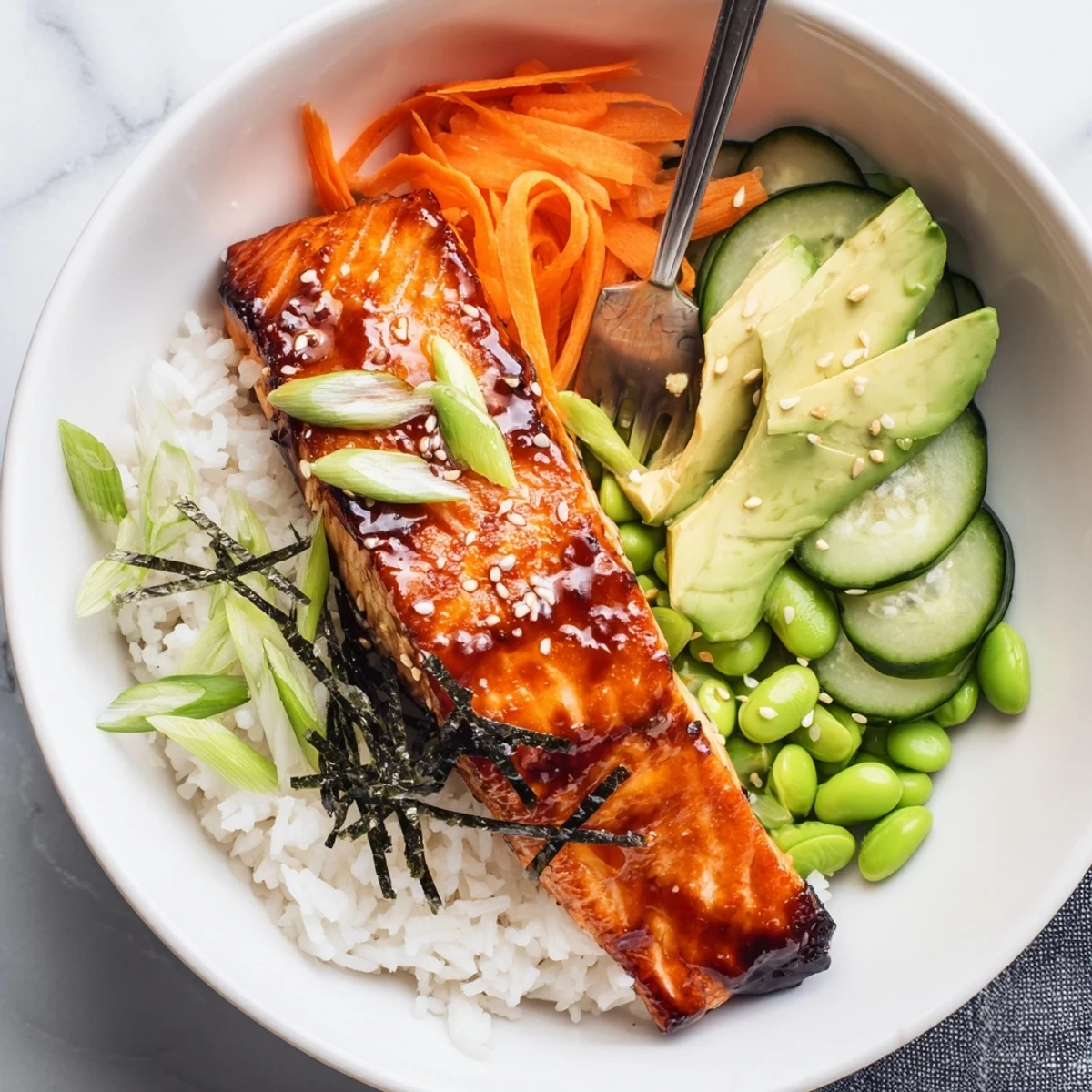 Pan-seared Crispy Salmon And Rice Bowl drizzled with tangy ginger-sesame sauce