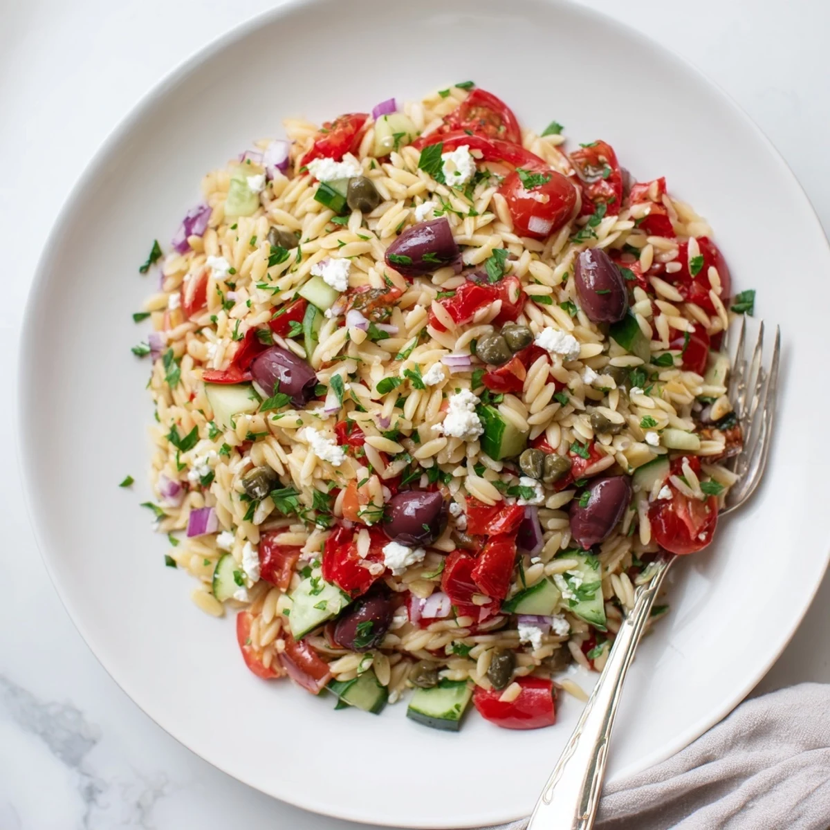 Creamy feta and tender orzo shine in this vibrant Mediterranean orzo pasta salad served fresh
