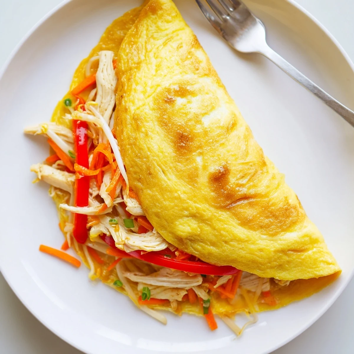 Savory Chinese omelette with sesame glaze, served fresh on a white plate