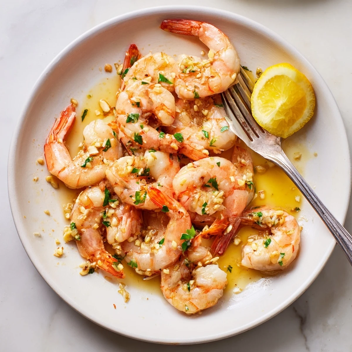 Golden buttered shrimp glistening in garlicky butter sauce with fresh parsley